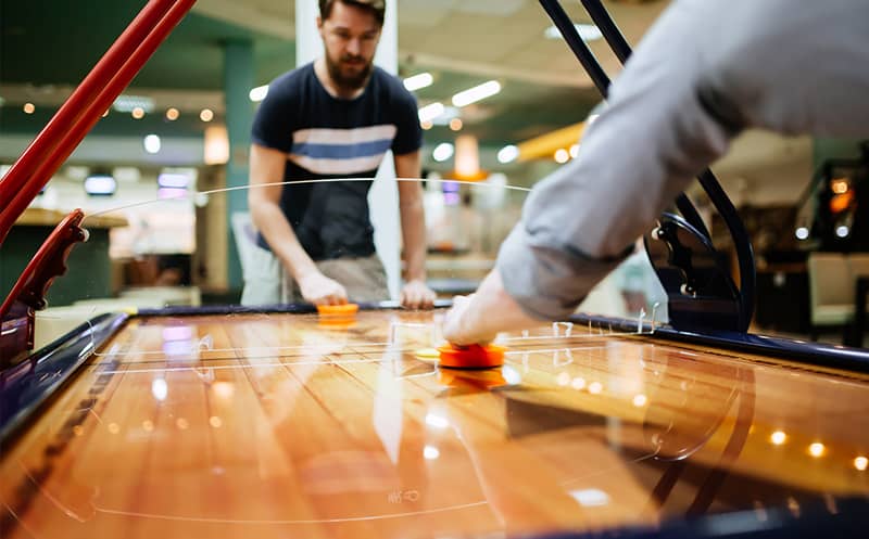 Employees playing air hockey