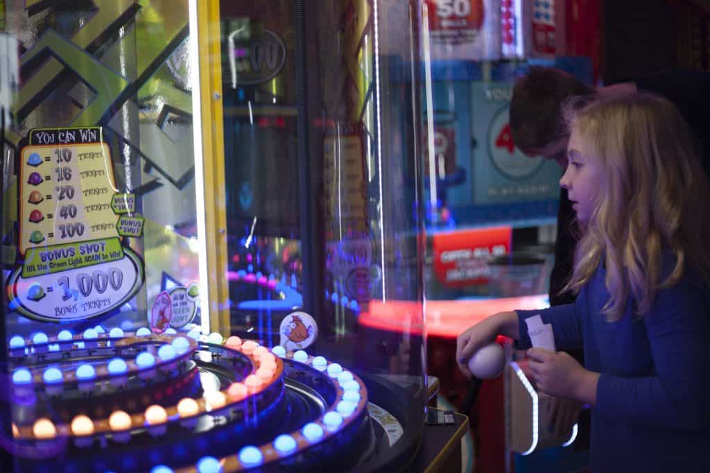 Kid Playing Arcade Game