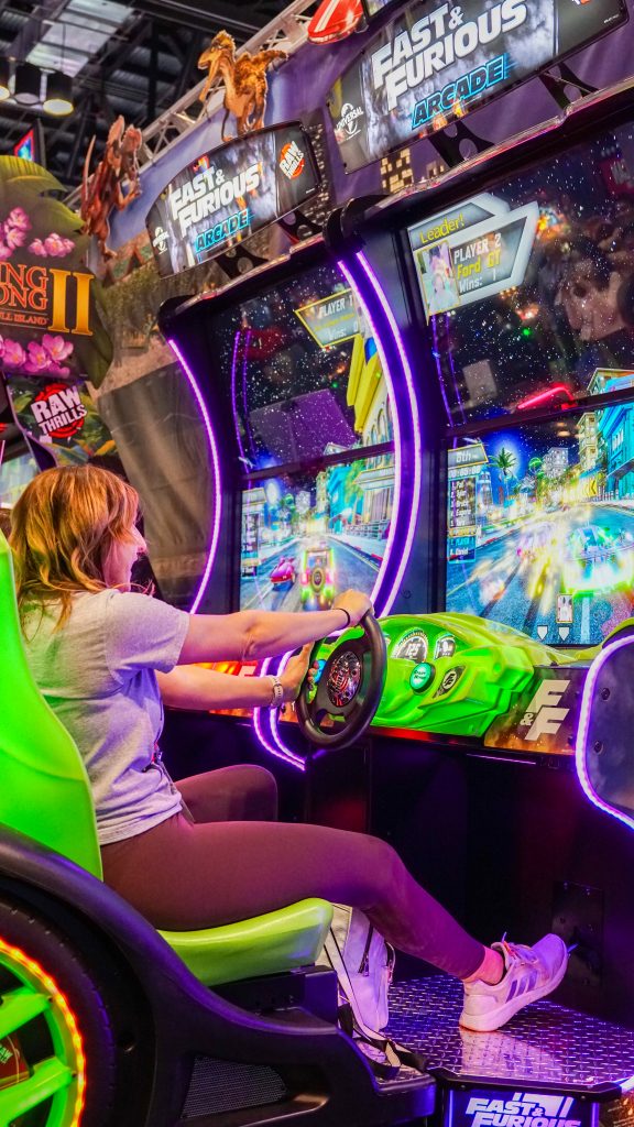 Woman playing Fast & Furious Arcade